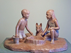 Photo of a sculpture of young boy and girl and a dog